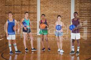 Group of high school team holding a basketball in the court