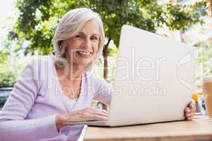 Portrait of senior woman using laptop
