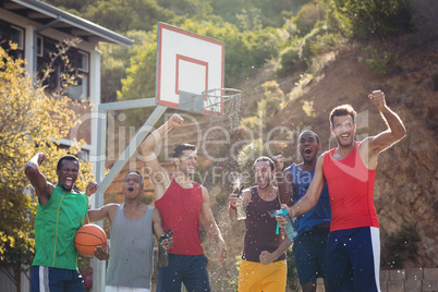 Basketball players celebrating by splashing water on each other