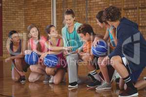 Female coach mentoring high school kids