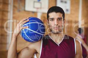 Confident basketball player holding a basketball