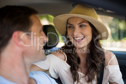 Cheerful couple sitting in car