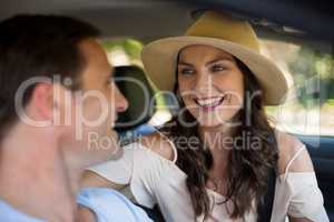 Cheerful couple sitting in car