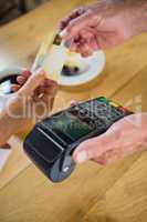 Senior woman making payment through credit card