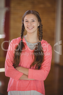 High school girl smiling while standing in basketball court