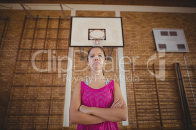 High school girl standing with her arms crossed