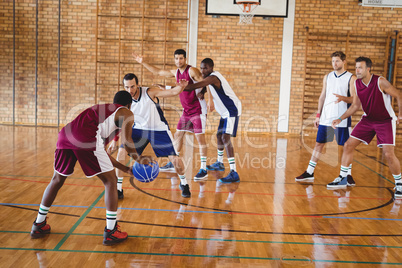 Basketball players playing in the court