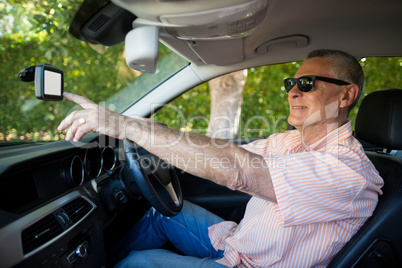 Man using mobile while driving car