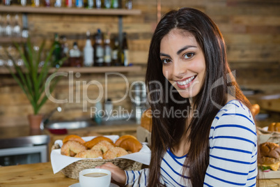 Portrait of woman having coffee at counter