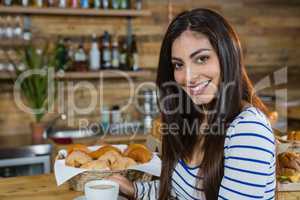Portrait of woman having coffee at counter