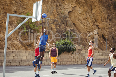Basketball players playing basketball in the court