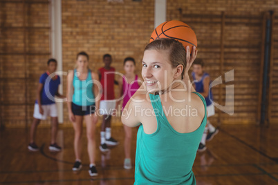 High school kids playing basketball in the court