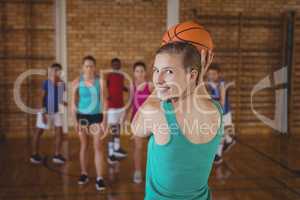 High school kids playing basketball in the court