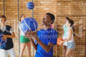 High school boy looking at basketball