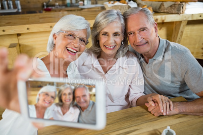 Group of senior friends taking selfie from mobile phone
