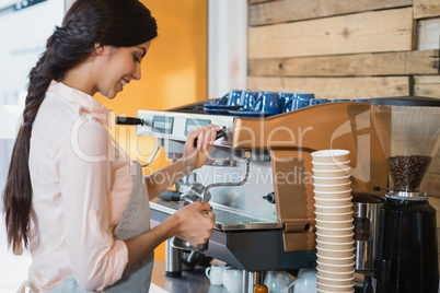 Waitress using coffeemaker