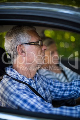 Senior man and woman in car