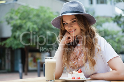 Portrait of beautiful woman sitting by food at table