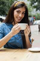 Portrait of smiling woman drinking coffee