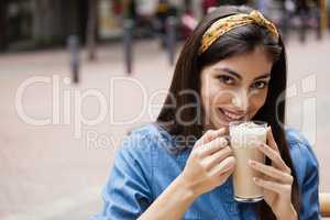Beautiful woman drinking cold coffee