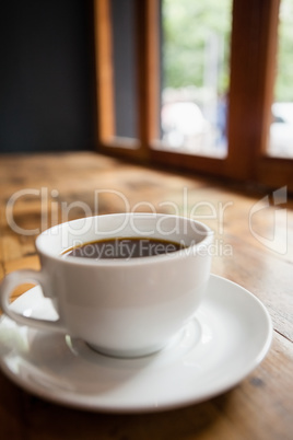 Coffee cup on wooden table at cafe shop