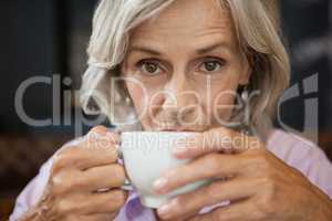 Portrait of senior woman drinking coffee