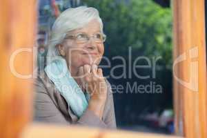 Senior woman looking away in cafe shop