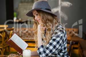 Side view of young woman reading book