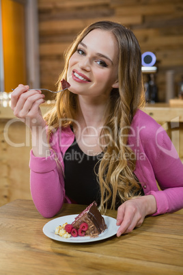 Portrait of beautiful woman having pastry