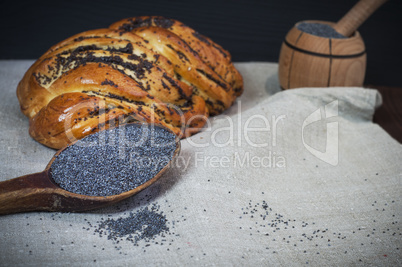 Poppy seeds in a brown wooden spoon