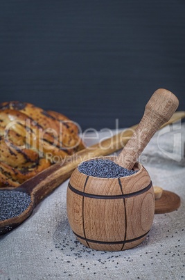 poppy seeds in a brown wooden mortar
