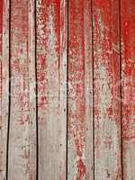 Old wooden planks with shelled red paint
