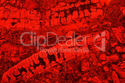 Firewood background with charcoal in red color