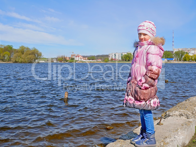 Schoolgirl on the dam in early spring