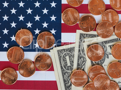 Dollar notes and coins and flag of the United States