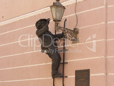 Sculpture of lamplighter "Uncle Kolya" on the wall in center of Uzhgorod photo: Uzhgorod, Ukraine - March 27, 2017