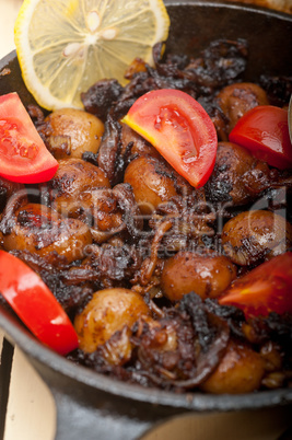 Baby cuttle fish roasted on iron skillet