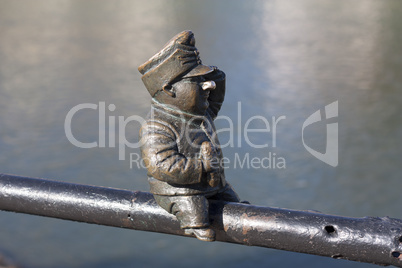 Small bronze statue of Good Soldier Svejk attached to the handrails at Kyivska embankment of the river Uzh in Uzhgorod Ukraine photo