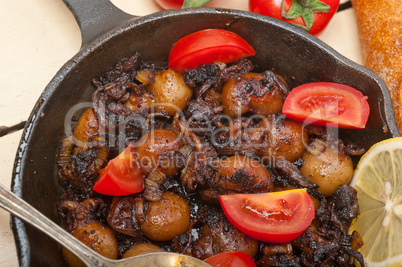 Baby cuttle fish roasted on iron skillet