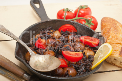 Baby cuttle fish roasted on iron skillet