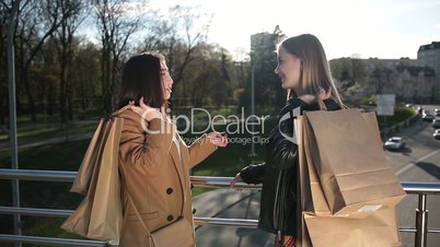 Girlfriends sharing impressions after shopping