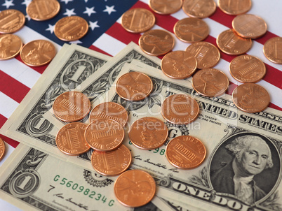 Dollar notes and coins and flag of the United States