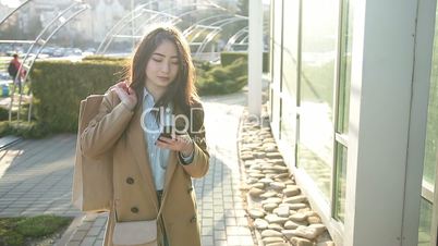 Elegant asian girl surfing the net with smartphone