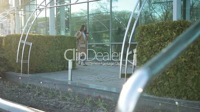 Cute asian girl with smartphone walking on street