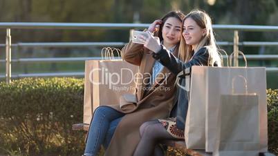 Two best friends taking selfie with smartphone