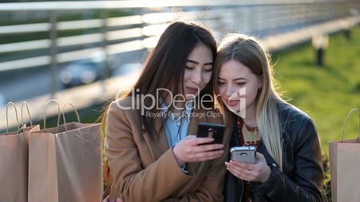 Euphoric friends watching videos on smartphone