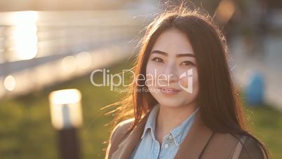 Portrait of beautiful asian woman smiling outdoors