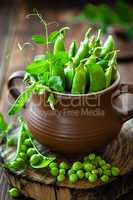 Fresh green peas on dark wooden rustic background