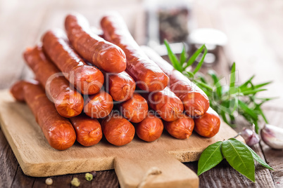 Sausages on wooden background