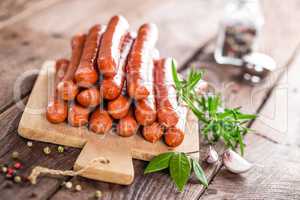 Sausages on wooden background